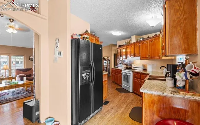 a kitchen with refrigerator and cabinets