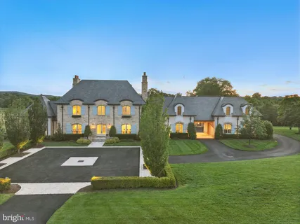 a spacious bedroom with a large bed and a chandelier