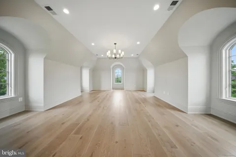 a view of a dining room with furniture and chandelier