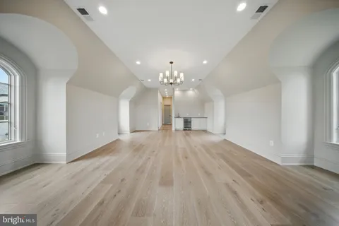 a large white kitchen with a stove top oven