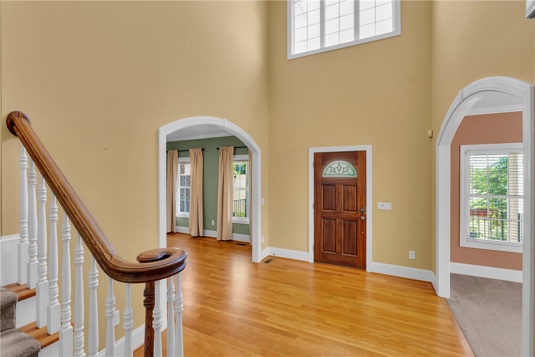 406 Hopewell Ridge Anderson, SC 29621 - Photo 5 of 46 This spacious entry foyer features high ceilings and polished hardwood flooring, creating an inviting atmosphere.