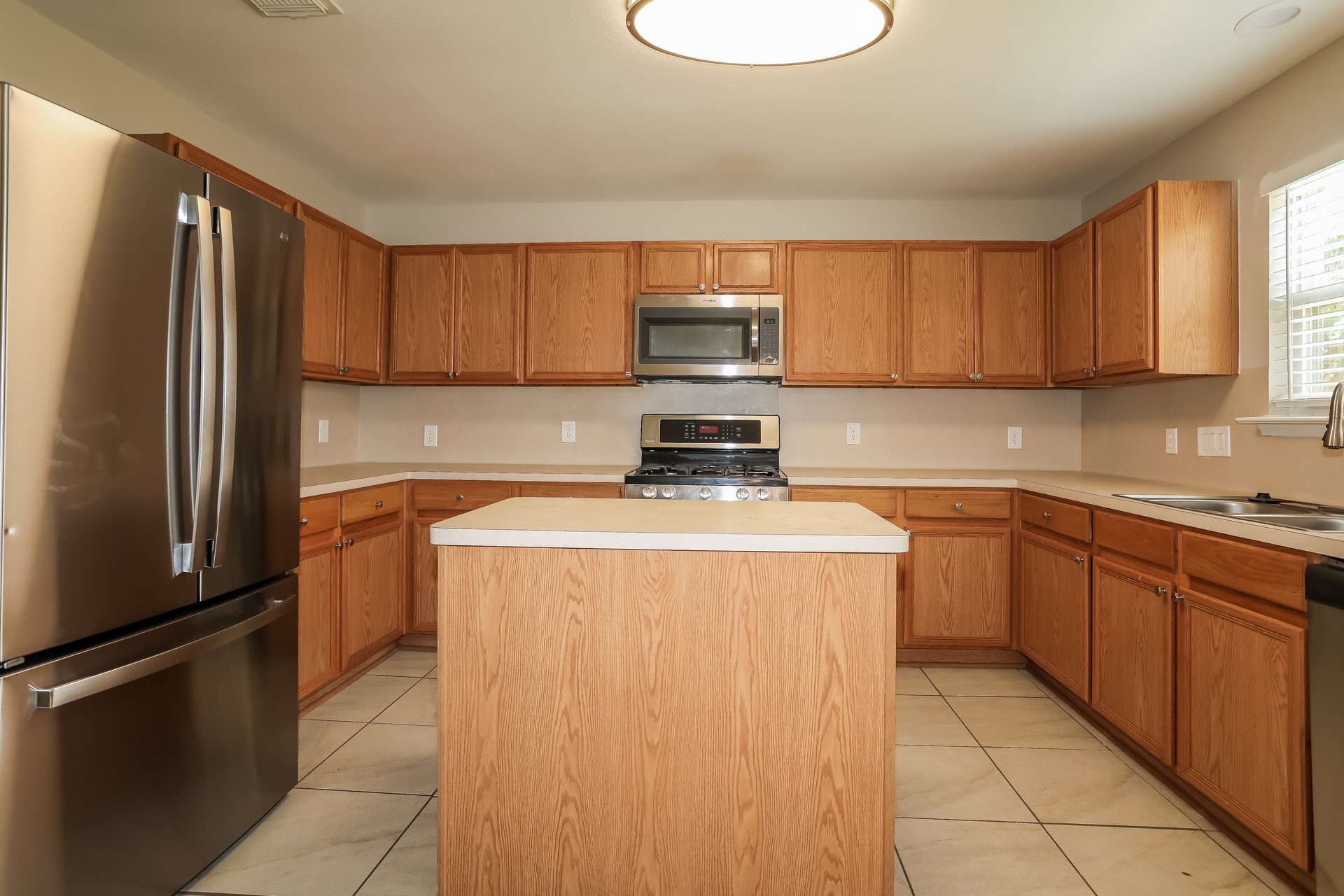 29511 Legends Pine Lane Spring, TX 77386 - Photo 6 of 17 a kitchen with a refrigerator sink and cabinets