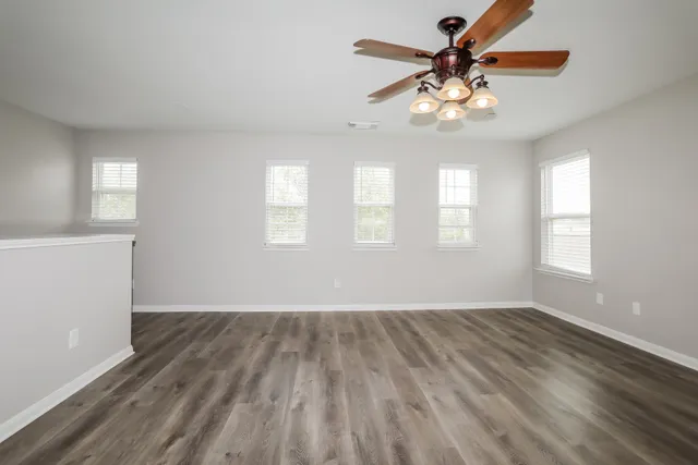 wooden floor in an empty room with a window