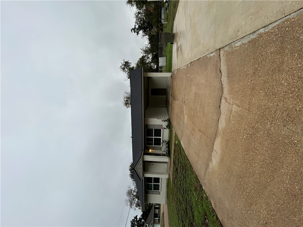 916 South Gordon Street Bryan, TX 77803 - Photo 2 of 8 a front view of a house with a yard and garage