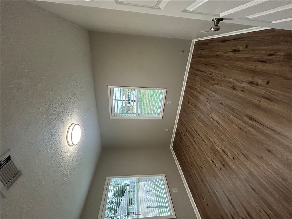 916 South Gordon Street Bryan, TX 77803 - Photo 5 of 8 an empty room with wooden floor and windows