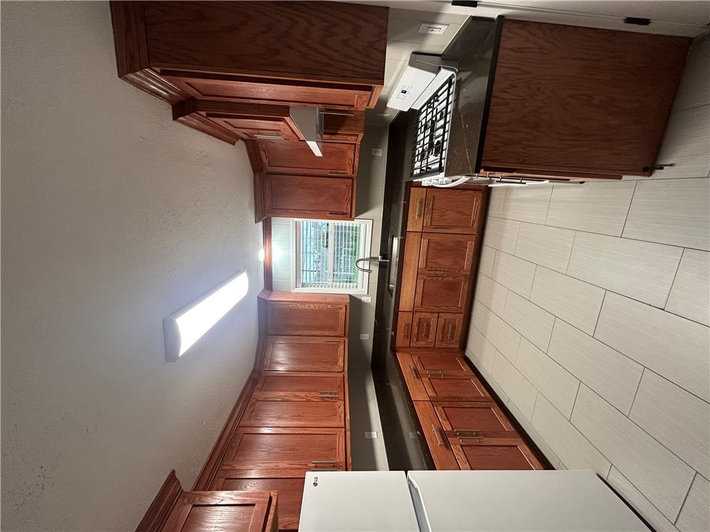 916 South Gordon Street Bryan, TX 77803 - Photo 6 of 8 a kitchen with stainless steel appliances granite countertop a stove a sink and a refrigerator
