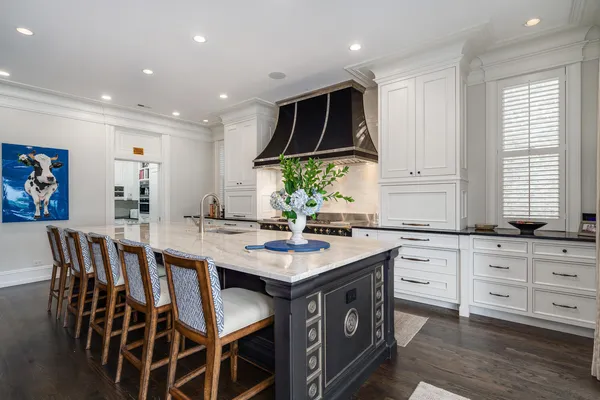 a kitchen with stainless steel appliances granite countertop a sink and a white wooden cabinets