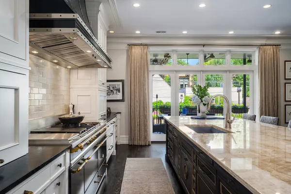 a kitchen with stainless steel appliances granite countertop lots of counter top and a wooden floors