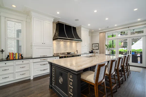 a kitchen with kitchen island a dining table and chairs