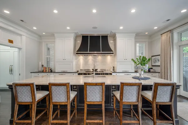 a large white kitchen with cabinets