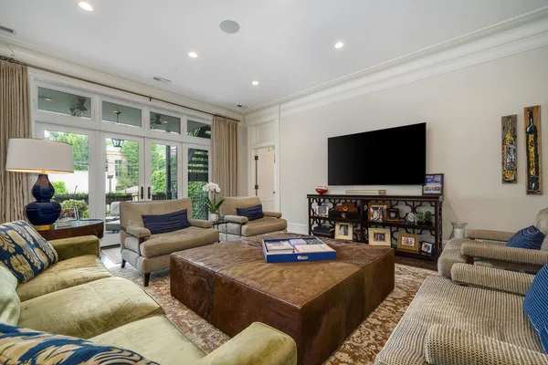 a living room with furniture wooden floor and a large window