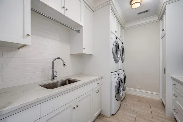 a bathroom with a double vanity sink mirror and shower