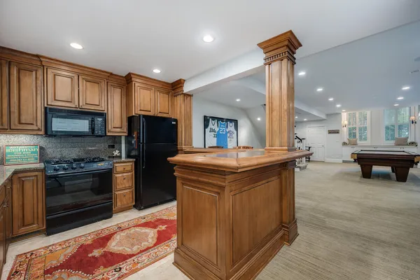 a bathroom with a granite countertop sink a toilet a mirror a bathtub and shower