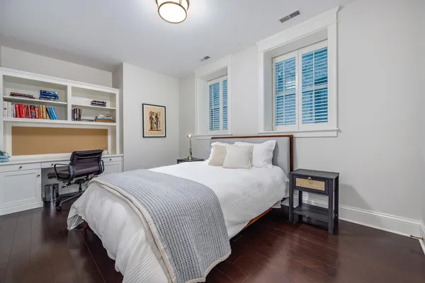 a bedroom with a bed and chair
