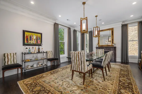 a dining room with furniture a chandelier and wooden floor
