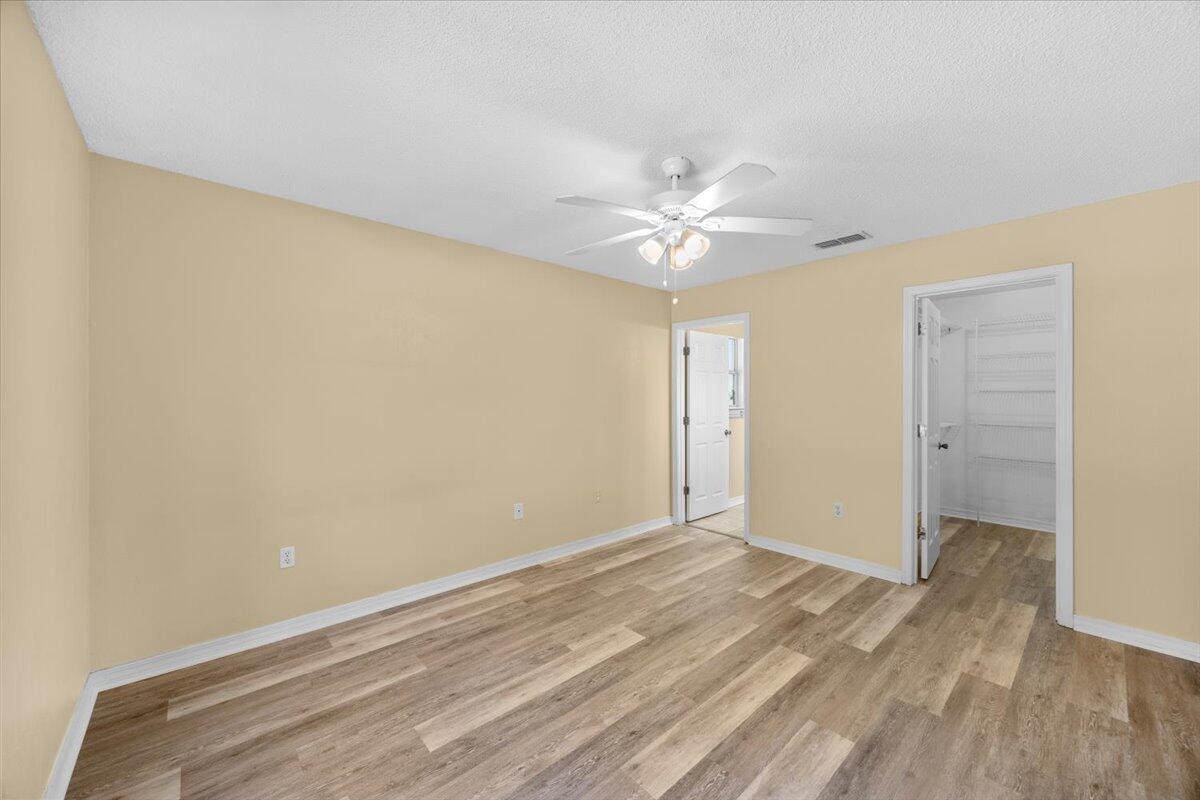 104 Cabana Way Crestview, FL 32536 - Photo 18 of 25 a view of a room with wooden floor and a ceiling fan