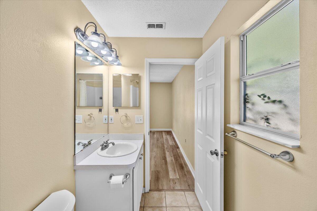 104 Cabana Way Crestview, FL 32536 - Photo 19 of 25 a bathroom with a sink and mirror with toilet