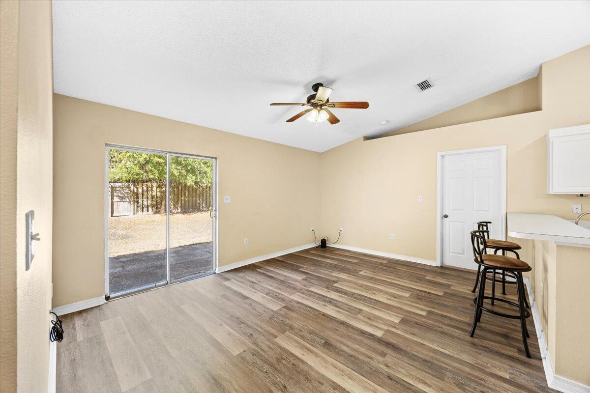 104 Cabana Way Crestview, FL 32536 - Photo 9 of 25 a view of an empty room with a window and wooden floor