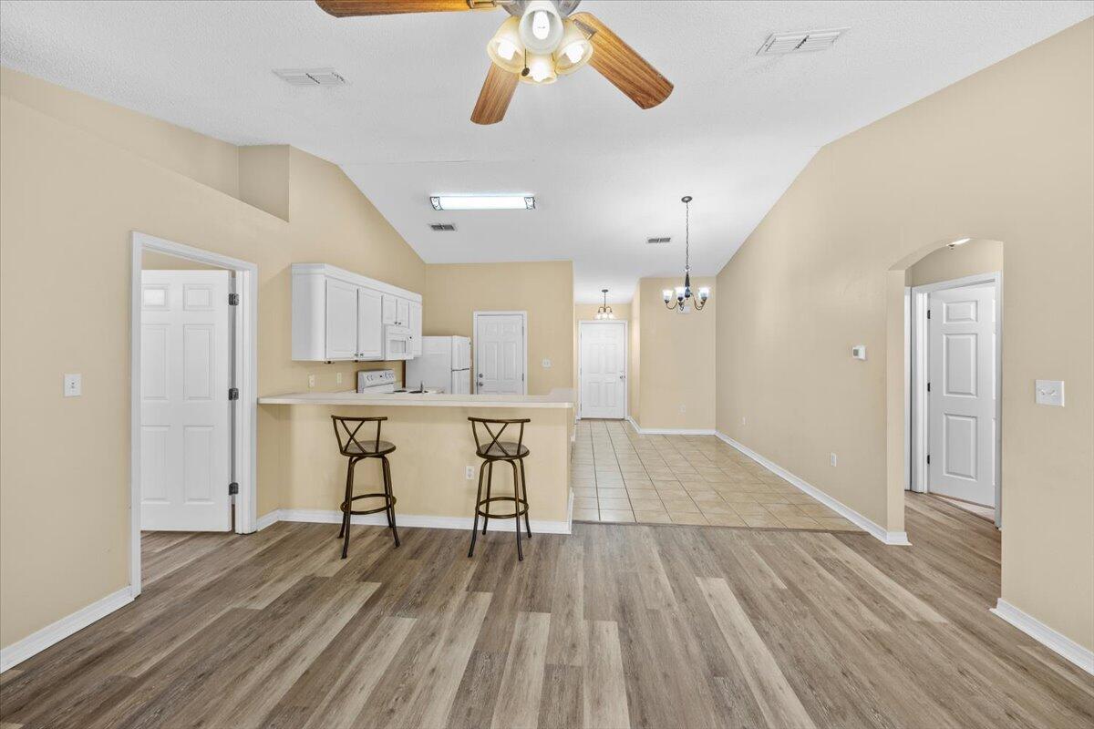 104 Cabana Way Crestview, FL 32536 - Photo 10 of 25 a view of a room with wooden floor and a kitchen view