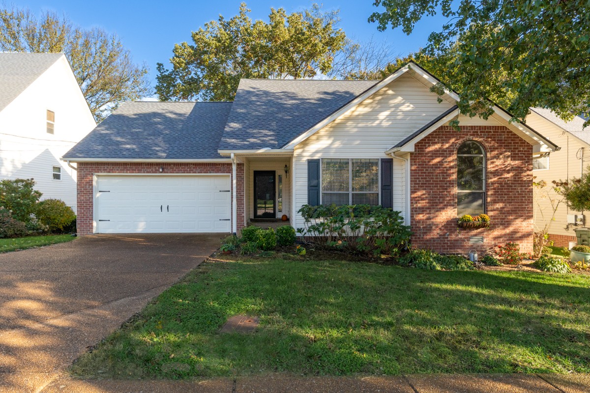 a view of a white house with a yard