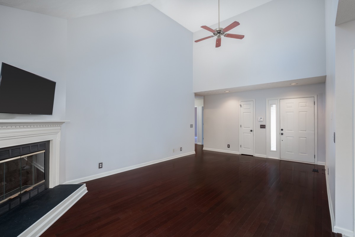 3817 Bryce Road Nashville, TN 37211 - Photo 12 of 26 an empty room with a fireplace and wooden floor