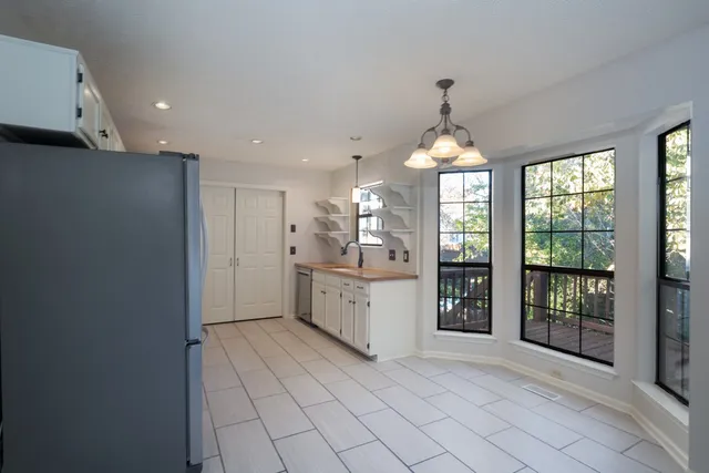 a kitchen with a refrigerator and a sink