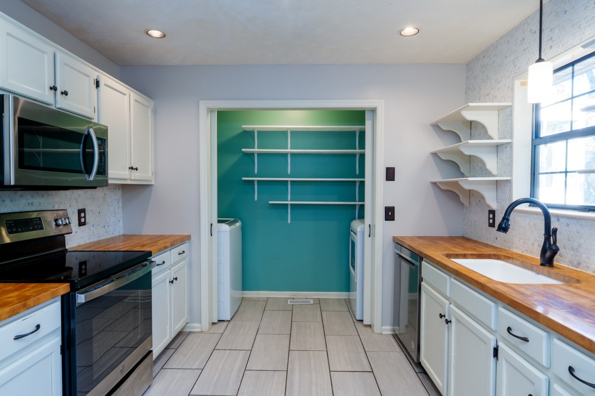 3817 Bryce Road Nashville, TN 37211 - Photo 10 of 26 a kitchen with stainless steel appliances granite countertop a stove a sink and a microwave