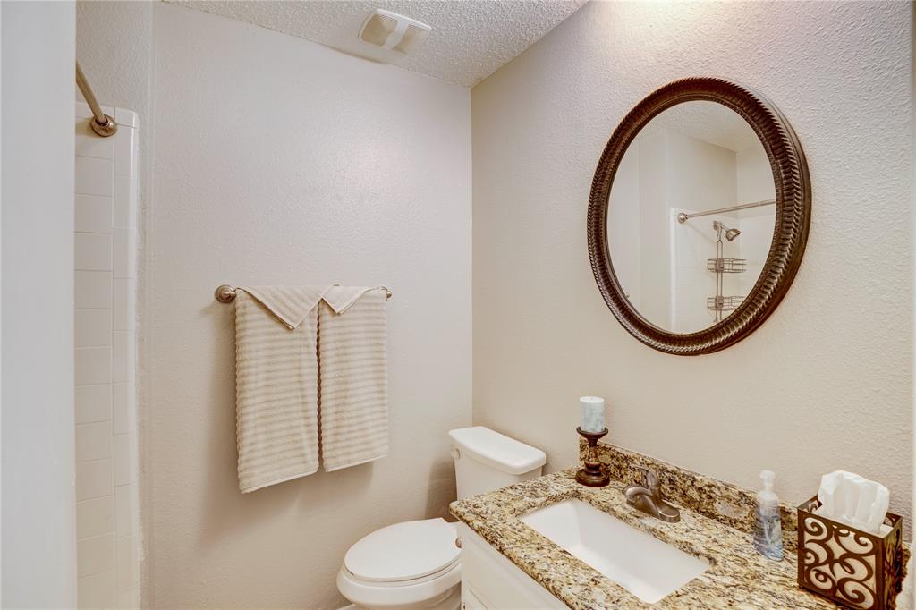 6028 Ridgecrest Drive Watauga, TX 76148 - Photo 27 of 40 a bathroom with a toilet a sink and a mirror