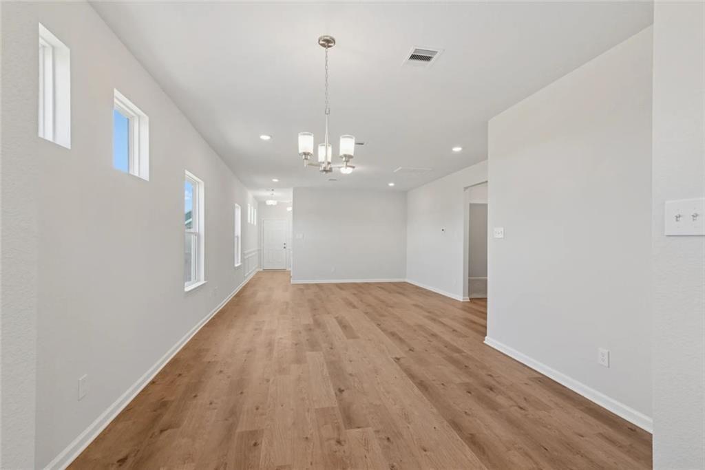 148 Red Oak Lane Calhoun, GA 30701 - Photo 8 of 13 a view of a hallway with wooden floor and chandelier