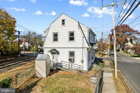 a view of a yard with wooden fence