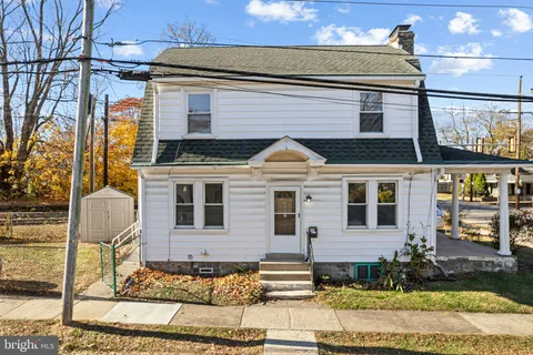 a view of a patio with table and chairs under an umbrella