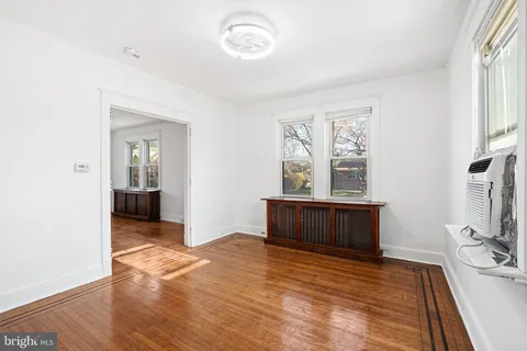 a view of a bedroom with furniture window and wooden floor