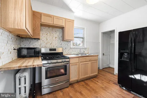 a kitchen with a stove and a refrigerator