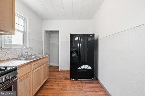 a kitchen with a sink and a refrigerator