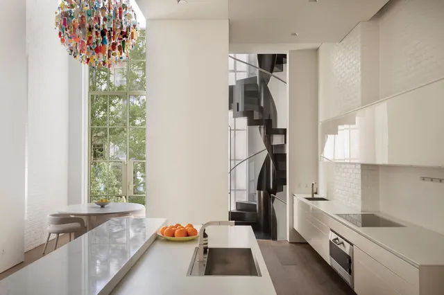 a kitchen with a refrigerator and a sink
