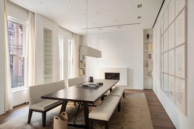 a view of a workspace with furniture and window