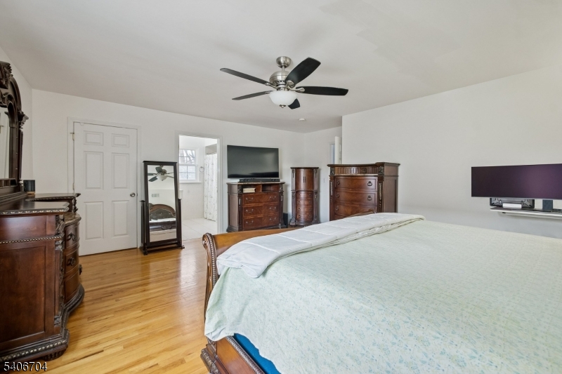 111 Todd Street Linden, NJ 07036 - Photo 12 of 34 a spacious bedroom with a bed and a flat screen tv
