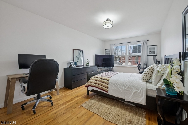 111 Todd Street Linden, NJ 07036 - Photo 18 of 34 a bedroom with a bed and wooden floor