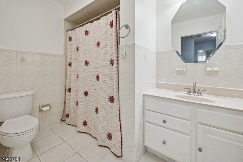 111 Todd Street Linden, NJ 07036 - Photo 23 of 34 a bathroom with a sink a toilet and shower