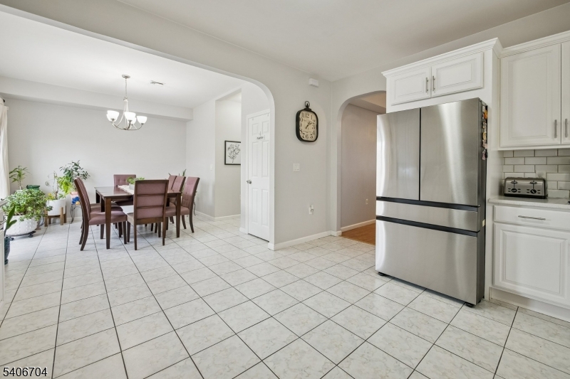111 Todd Street Linden, NJ 07036 - Photo 7 of 34 a kitchen with stainless steel appliances granite countertop a refrigerator and a dining table