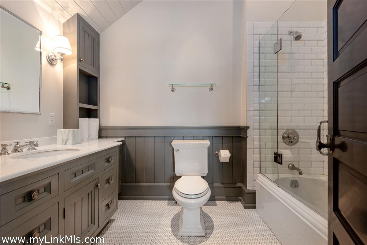 37 Sankaty Head Road Nantucket, MA 02554 - Photo 33 of 65 a bathroom with a toilet sink a mirror a bathtub and shower