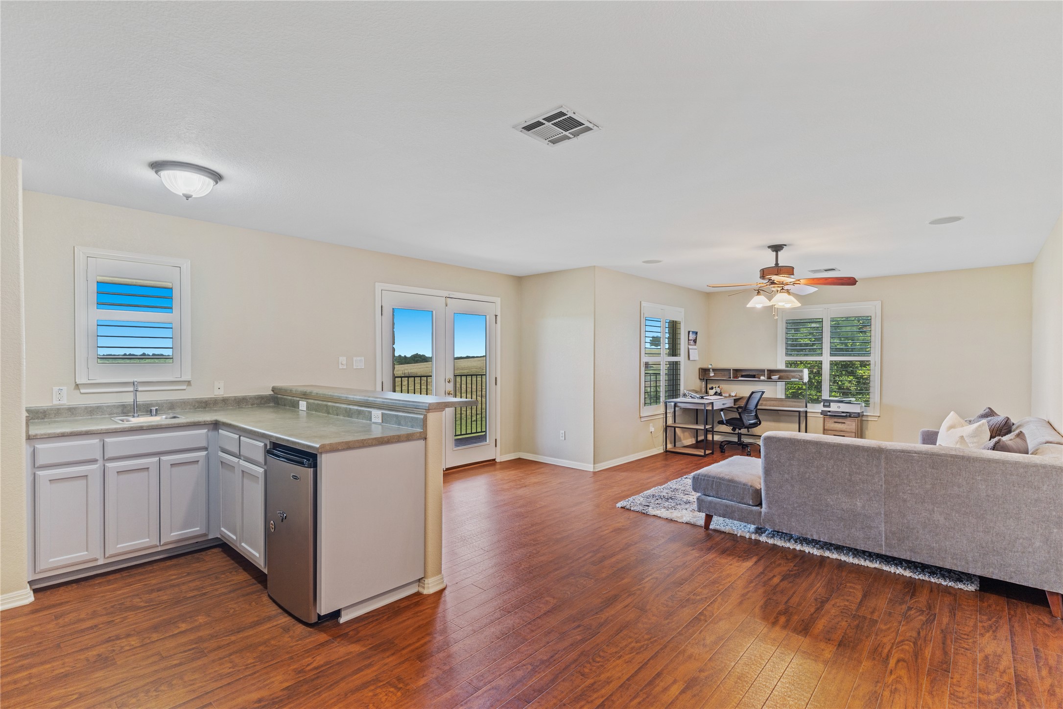 20145 Janak Road Coupland, TX 78615 - Photo 24 of 40 An inviting open-concept gameroom/living area/office with a convenient wet bar and access to the deck for breathtaking views!