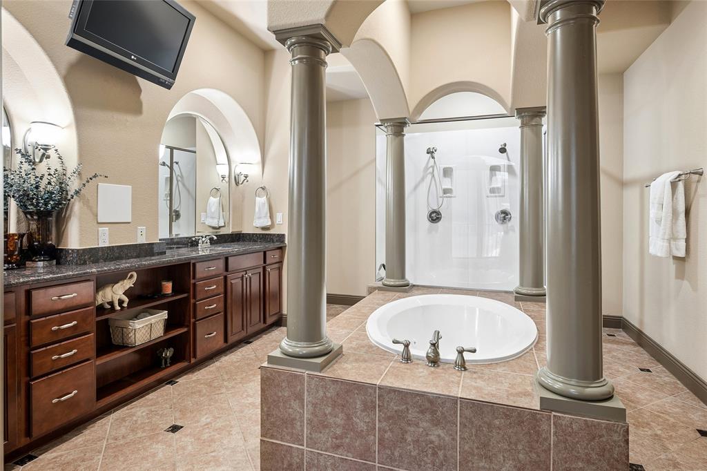 835 Rockingham Drive Irving, TX 75063 - Photo 16 of 27 a bathroom with a granite countertop tub sink and mirror