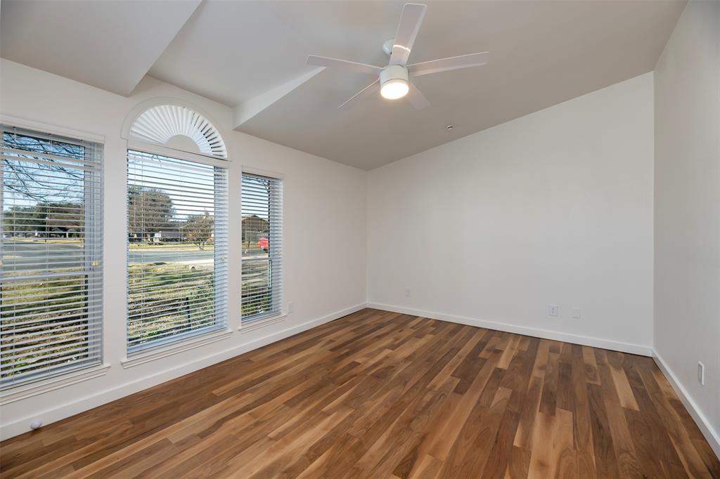 485 Ashley Lane Roanoke, TX 76262 - Photo 12 of 28 an empty room with wooden floor fan and windows