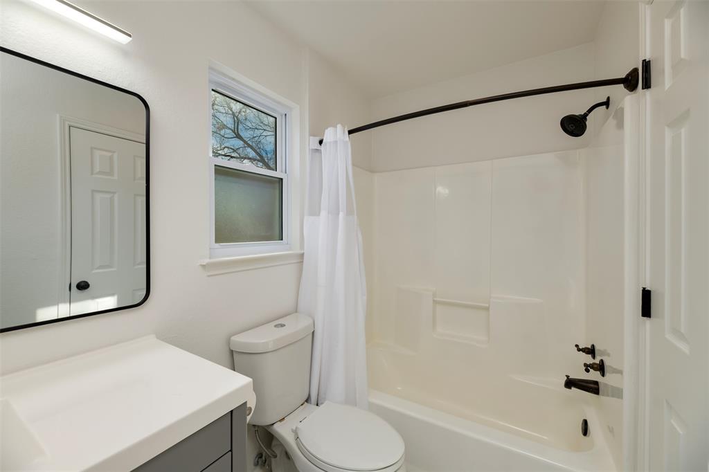 485 Ashley Lane Roanoke, TX 76262 - Photo 13 of 28 a bathroom with a sink a toilet and shower
