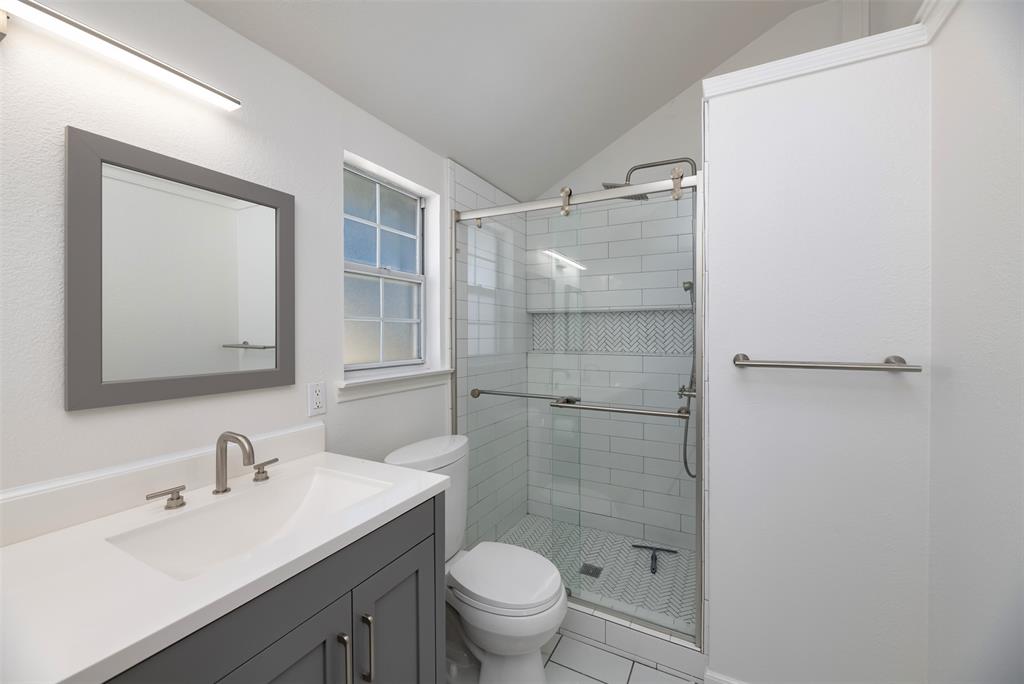485 Ashley Lane Roanoke, TX 76262 - Photo 20 of 28 a bathroom with a sink toilet a mirror and shower
