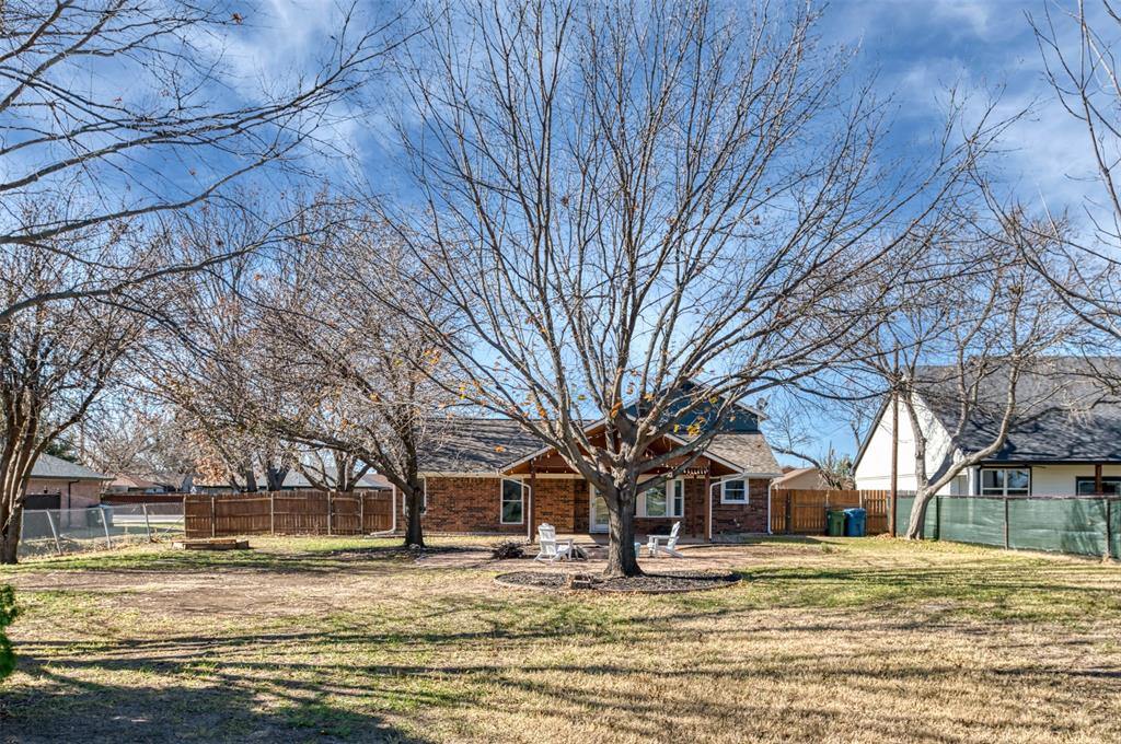 485 Ashley Lane Roanoke, TX 76262 - Photo 26 of 28 a house with trees in the background