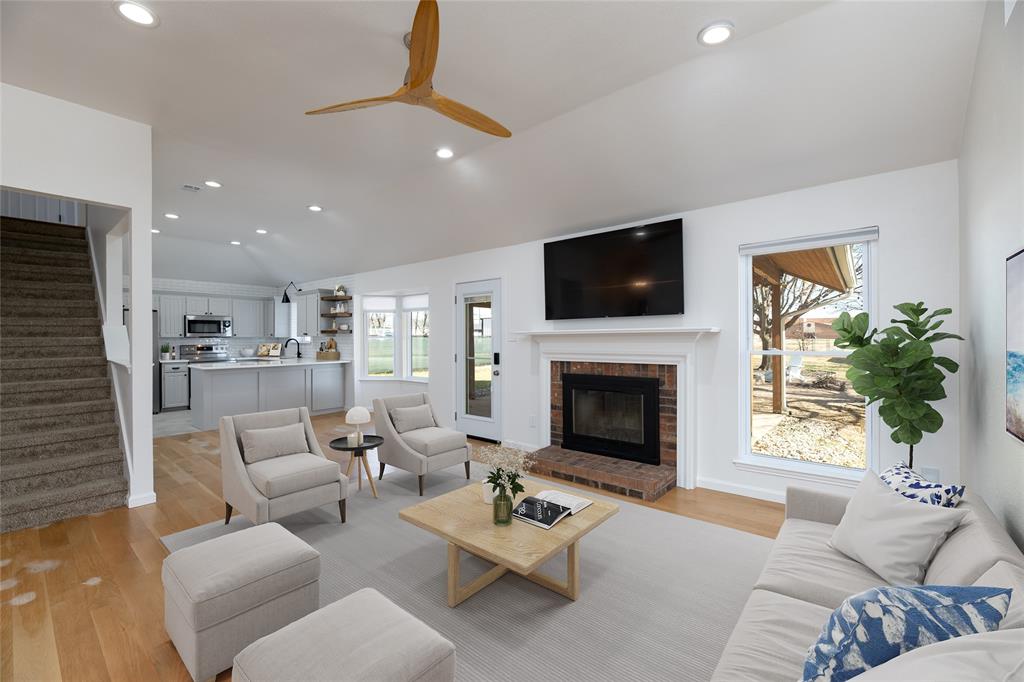 485 Ashley Lane Roanoke, TX 76262 - Photo 5 of 28 a living room with furniture a fireplace and a flat screen tv