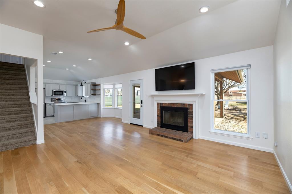 485 Ashley Lane Roanoke, TX 76262 - Photo 6 of 28 a view of a livingroom with a fireplace a fireplace and a window