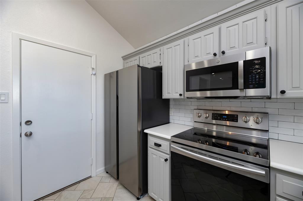 485 Ashley Lane Roanoke, TX 76262 - Photo 8 of 28 a kitchen with stainless steel appliances a refrigerator stove and microwave